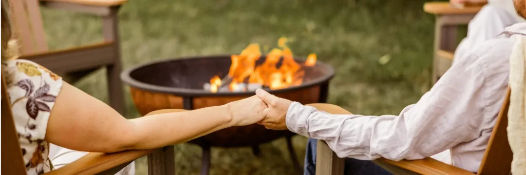 Holding hands on Berlin Gardens outdoor furniture