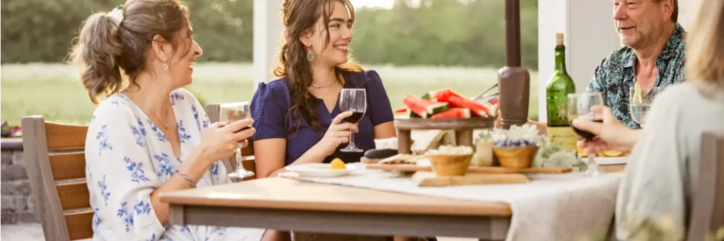 Family laughing at outdoor dining set